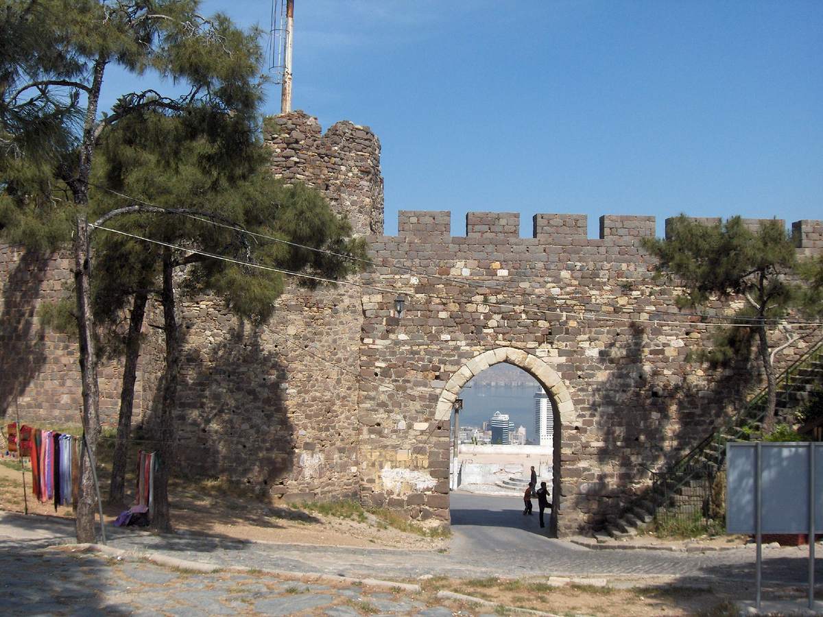 The walls of Kadifekale, the old Mount Pagos, with modern İzmir and its gulf framed in the gate